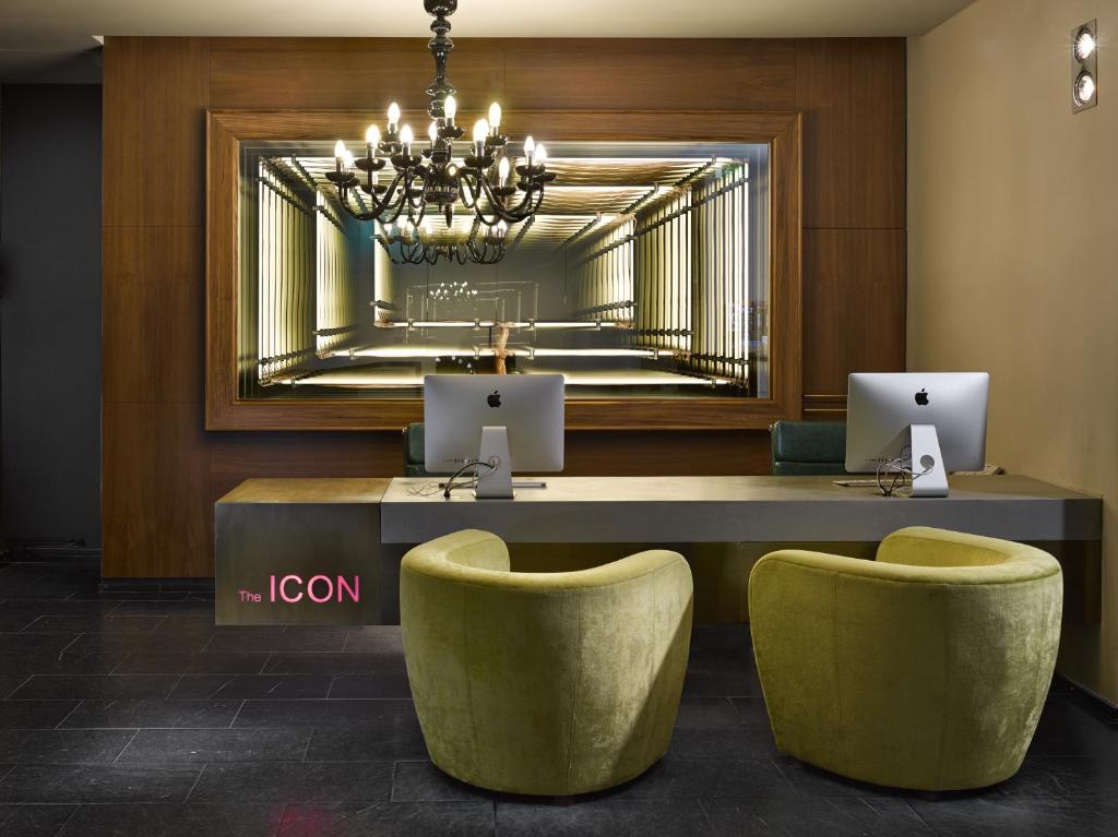a lobby with a table and two chairs and a mirror at The ICON Hotel & Lounge in Prague