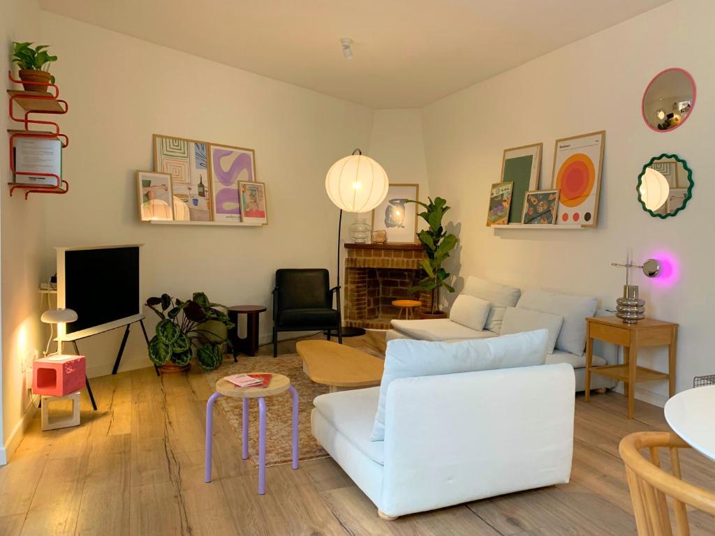 a living room with white furniture and a fireplace at Nordic! 1 Bedroom Apartment in Puerto de la Cruz