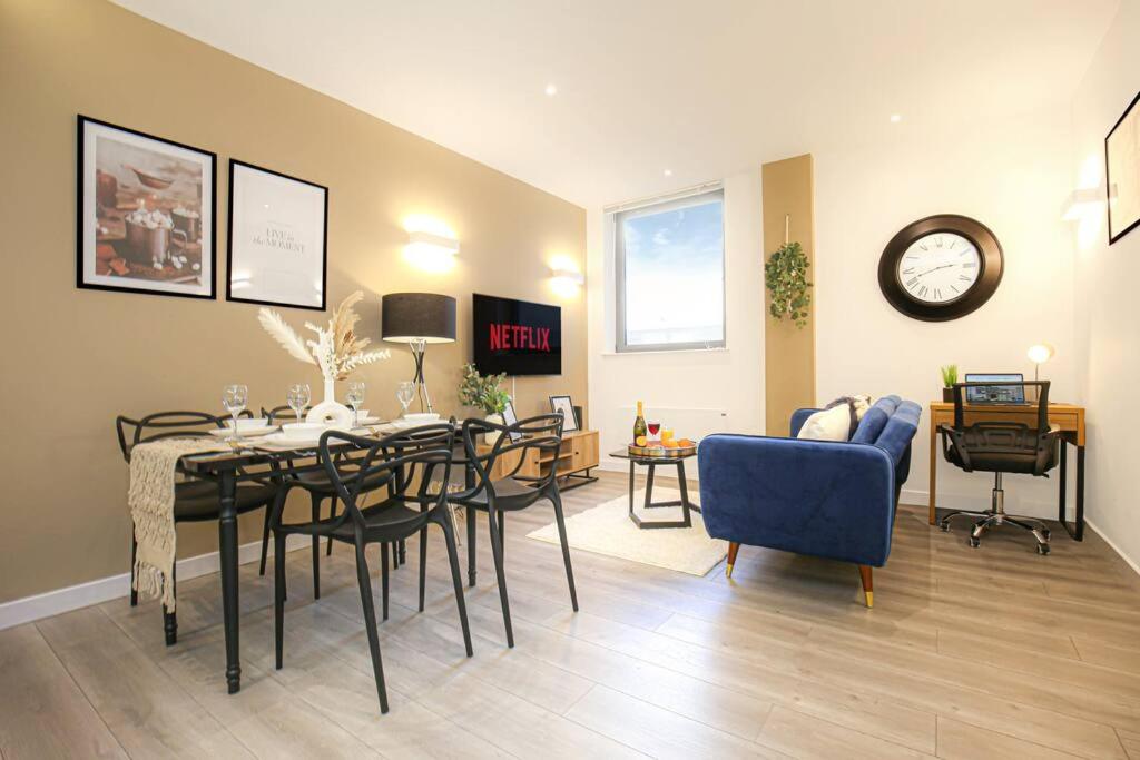 a dining room and living room with a table and chairs at Luxury Apartment - Close to City Centre - Free Parking, Fast Wifi, SmartTV with Sky and Netflix by Yoko Property in Milton Keynes