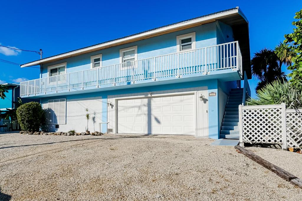 a blue and white house with a garage at Tollgate Tides in Islamorada