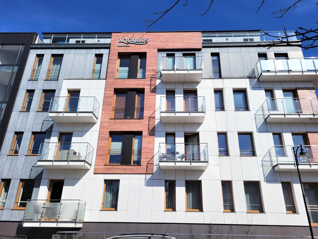 a tall building with balconies on the side of it at Apartament Bryza Aquarius - z miejscem parkingowym in Ustka