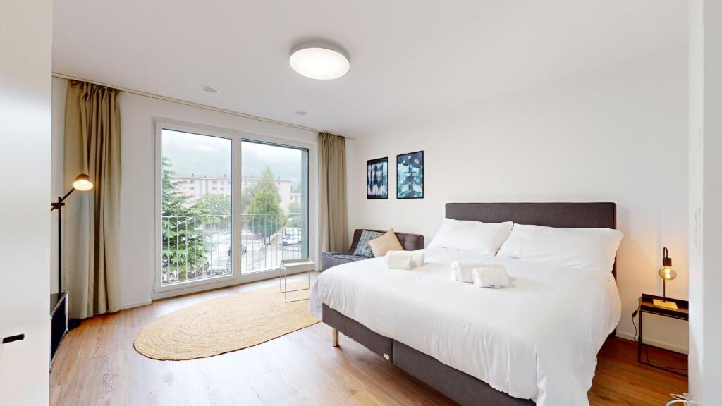 Postel nebo postele na pokoji v ubytování Bright & modern apartments in Sion