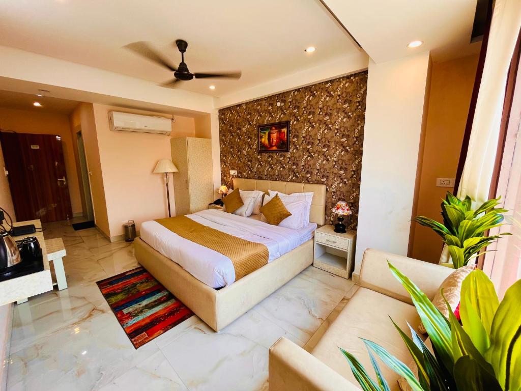 a bedroom with a large bed in a room at Tirath View Central Hotel - A Comfortable Stay in Haridwār