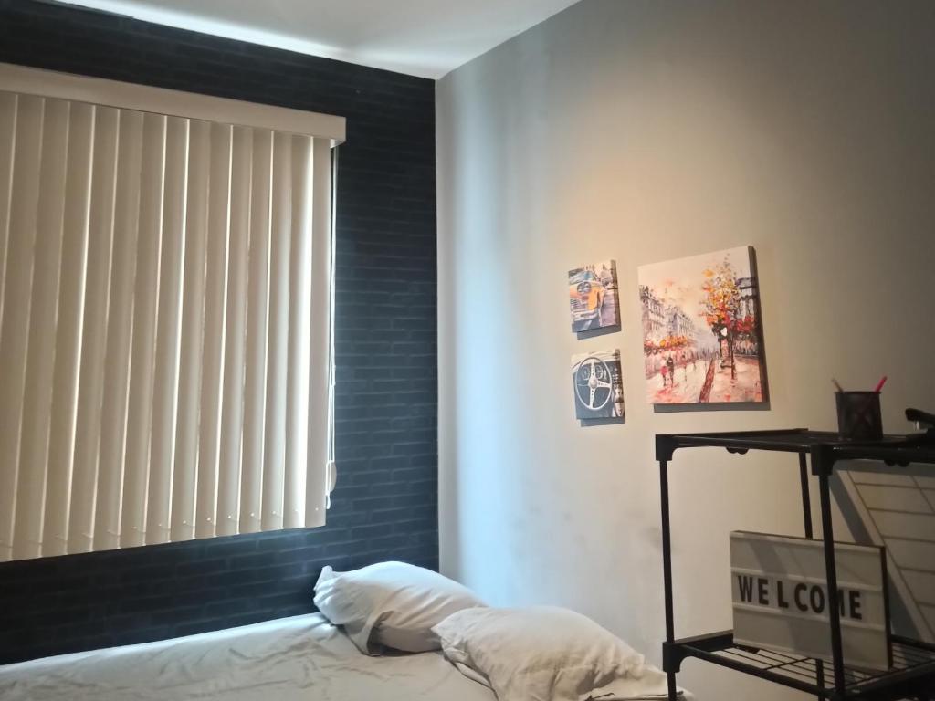 a bedroom with a black headboard and a window at AP Central Park in Feira de Santana