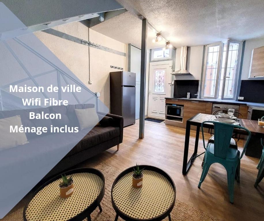 a kitchen and a living room with a table and chairs at Maison La Petite Bleue - Balcon - Wifi Fibre - Menage inclus in Tarbes