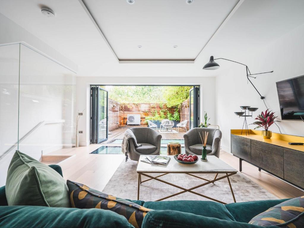 a living room with a couch and a table at Pass the Keys London Modern EcoTownhouse Dulwich in London