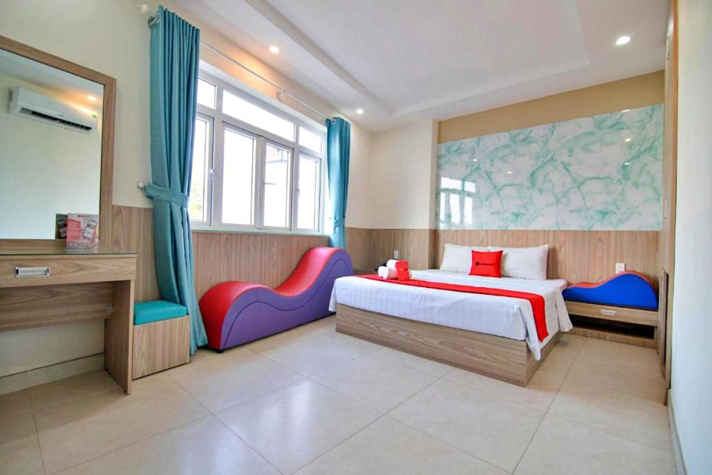 胡志明市的住宿－HANZ Love Hotel Tran Binh Trong，一间卧室配有一张床和两张五彩缤纷的椅子