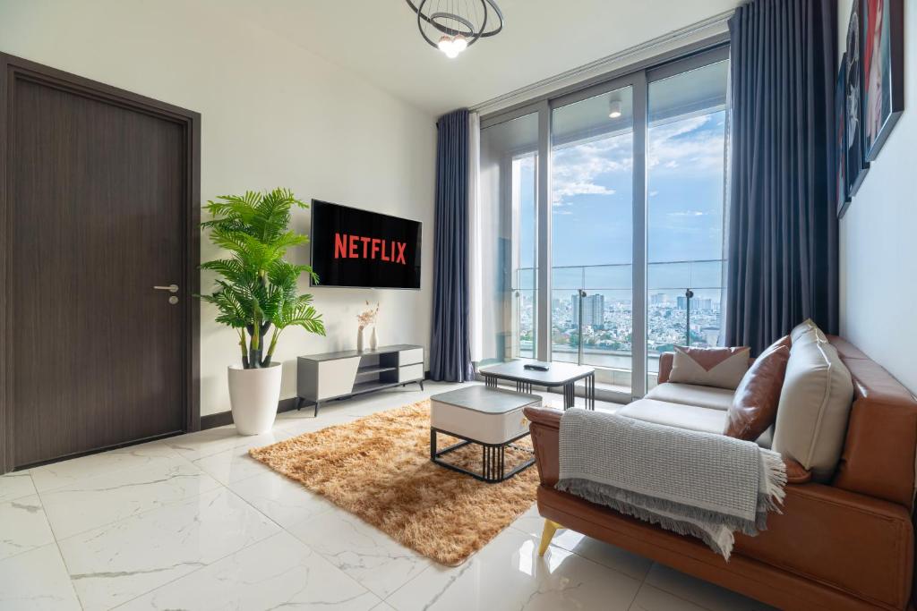 a living room with a couch and a large window at Fully-Equipped Luxury Condo in Central Ho Chi Minh with Downtown and River View in Ho Chi Minh City