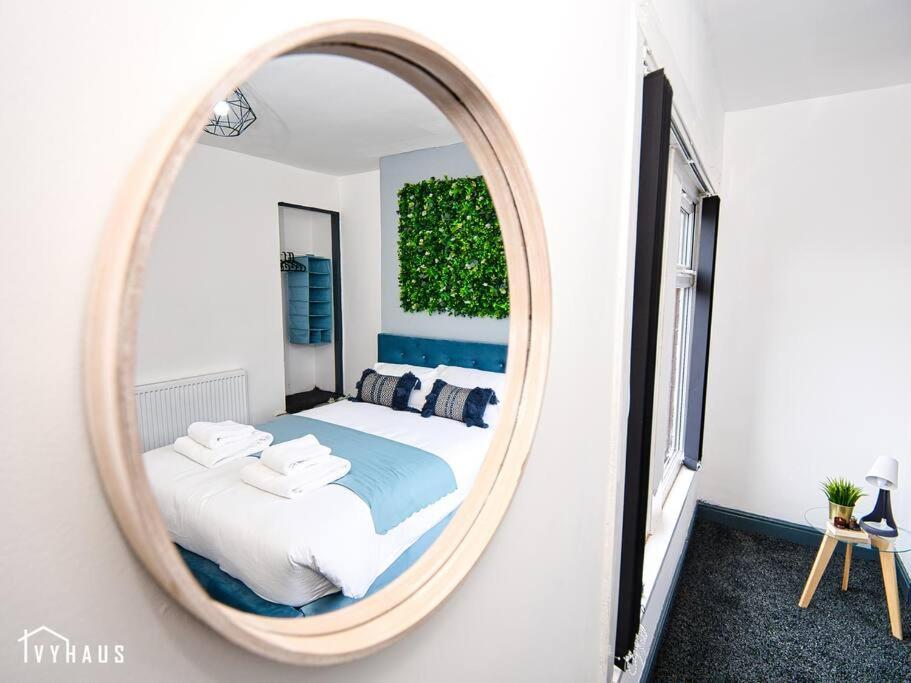 a bedroom with a large mirror on the wall at BIRMINGHAM HOME : STYLISH : WELCOMES ALL in Birmingham