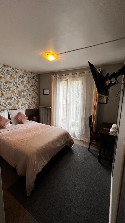 Postel nebo postele na pokoji v ubytování Hôtel Marie Louise