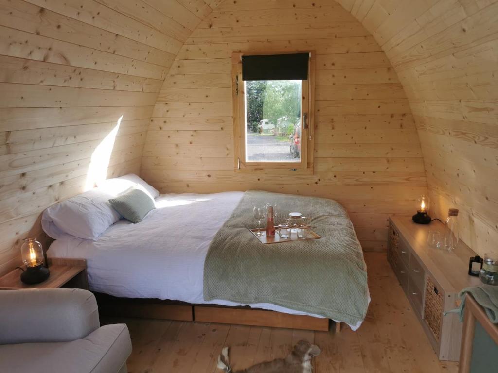 a bedroom with a bed in a log cabin at Y Nyth - The nest in Bridgend