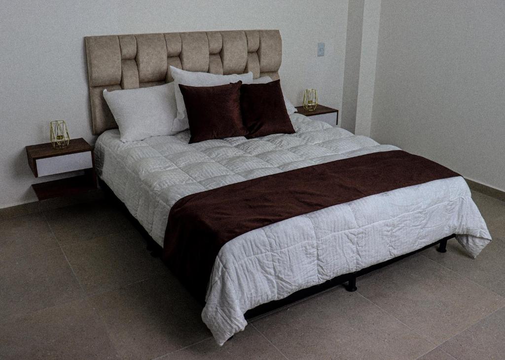 a large bed in a bedroom with two night stands at VIVA ALCALA in Envigado