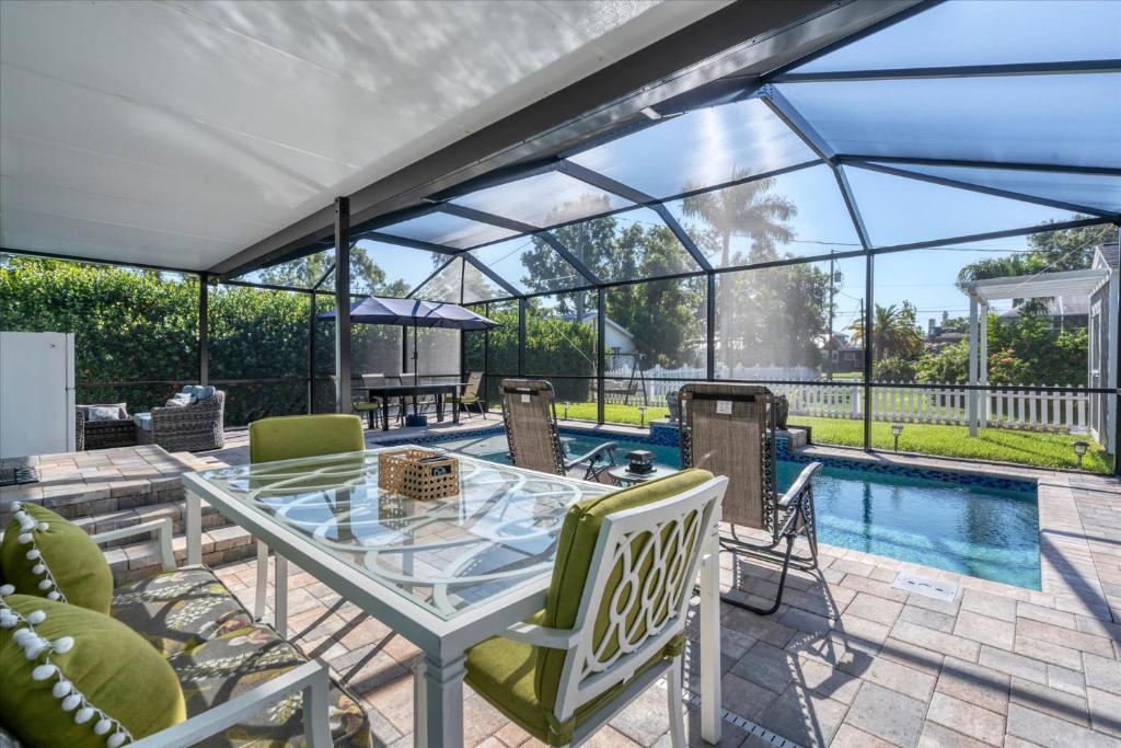 a patio with a table and chairs and a pool at 509 W Olympia in Punta Gorda
