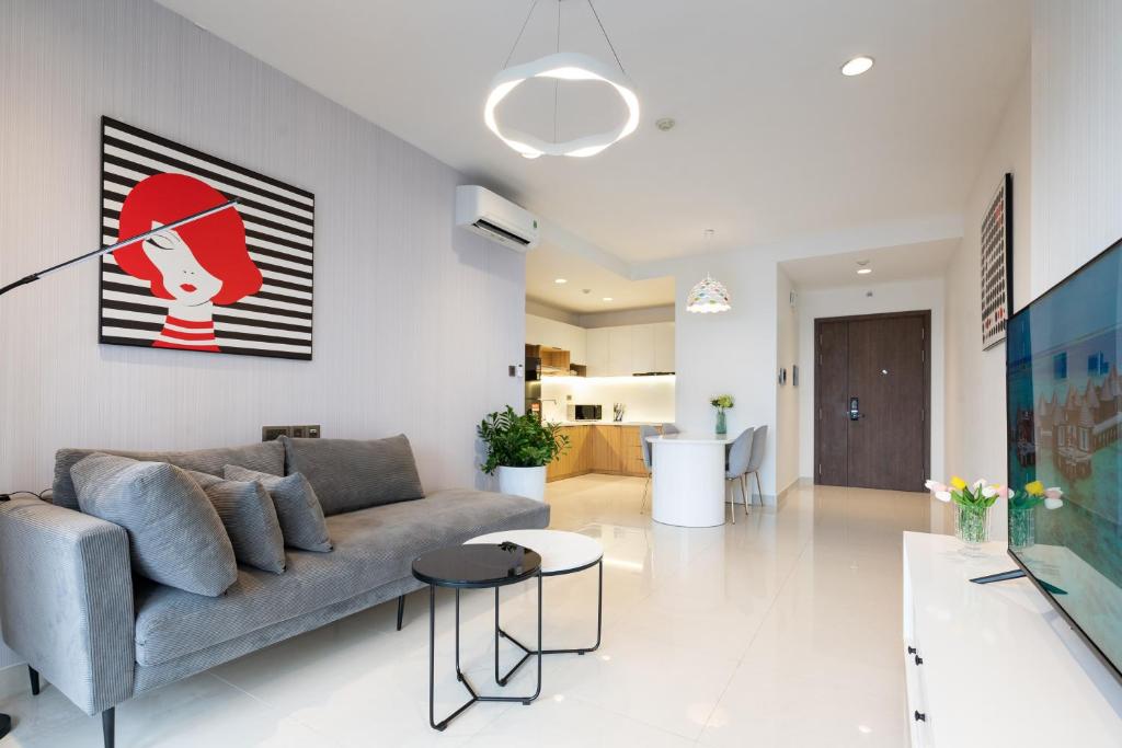 a living room with a couch and a table at MIN' Apartment - Saigon Royal - Upscale Apartment - near Ben Thanh - Downtown in Ho Chi Minh City
