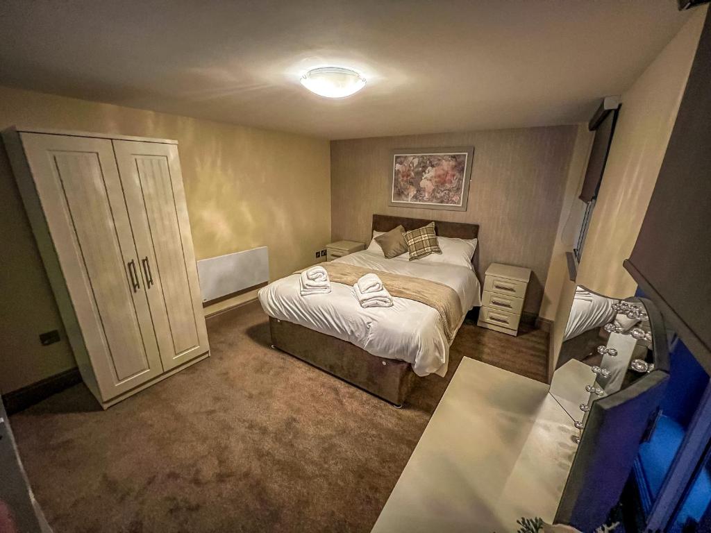 a bedroom with a bed with towels on it at Grant House in Boston