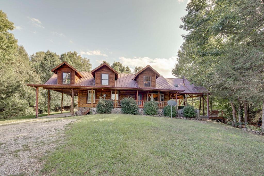 a large wooden house with a large yard at Peaceful Whitley City Cabin on 10 Wooded Acres! in Whitley City