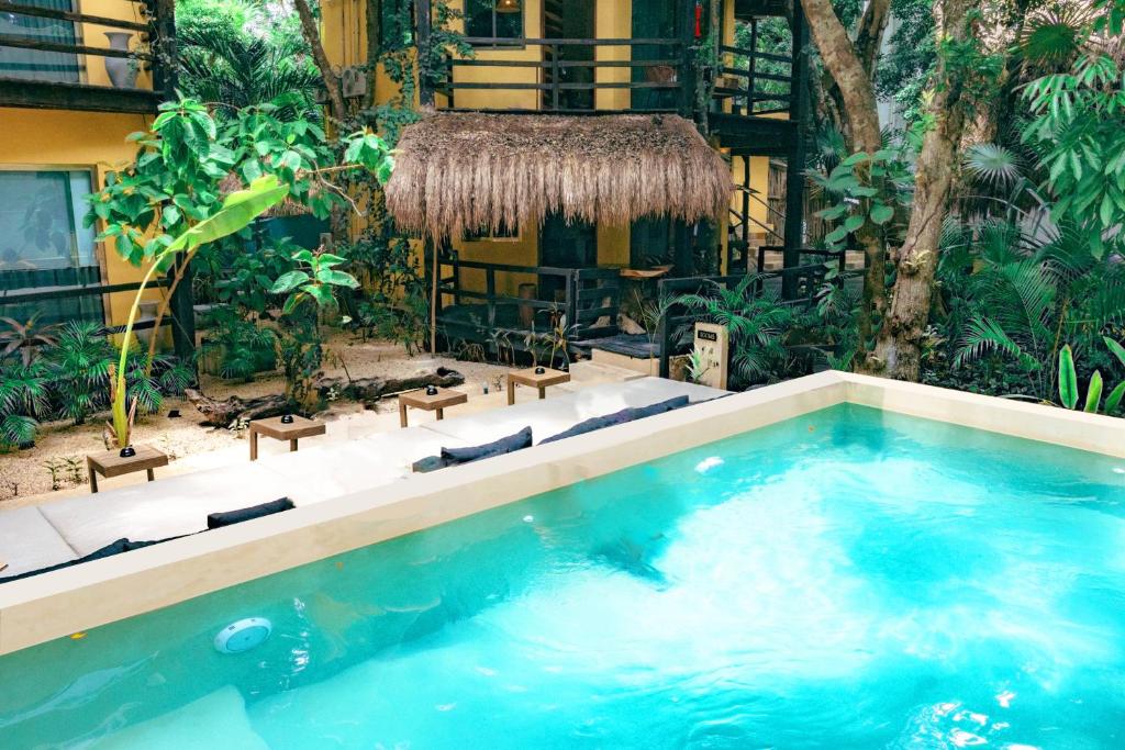 a swimming pool in the middle of a resort at Terasu Riviera Maya Hotel & Spa, en Xcaret in Playa del Carmen