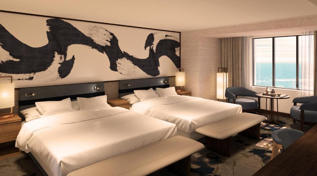 a hotel room with two beds and a large painting on the wall at Nobu Hotel at Caesars Atlantic City in Atlantic City
