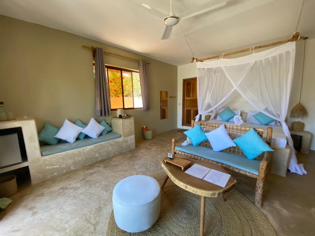 a living room with a couch and a table at Zen Boutique Resort in Jambiani