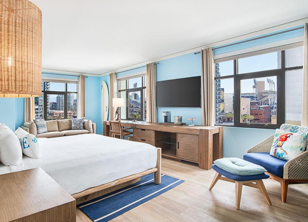 a hotel room with a large bed and a tv at Margaritaville Hotel San Diego Gaslamp Quarter in San Diego