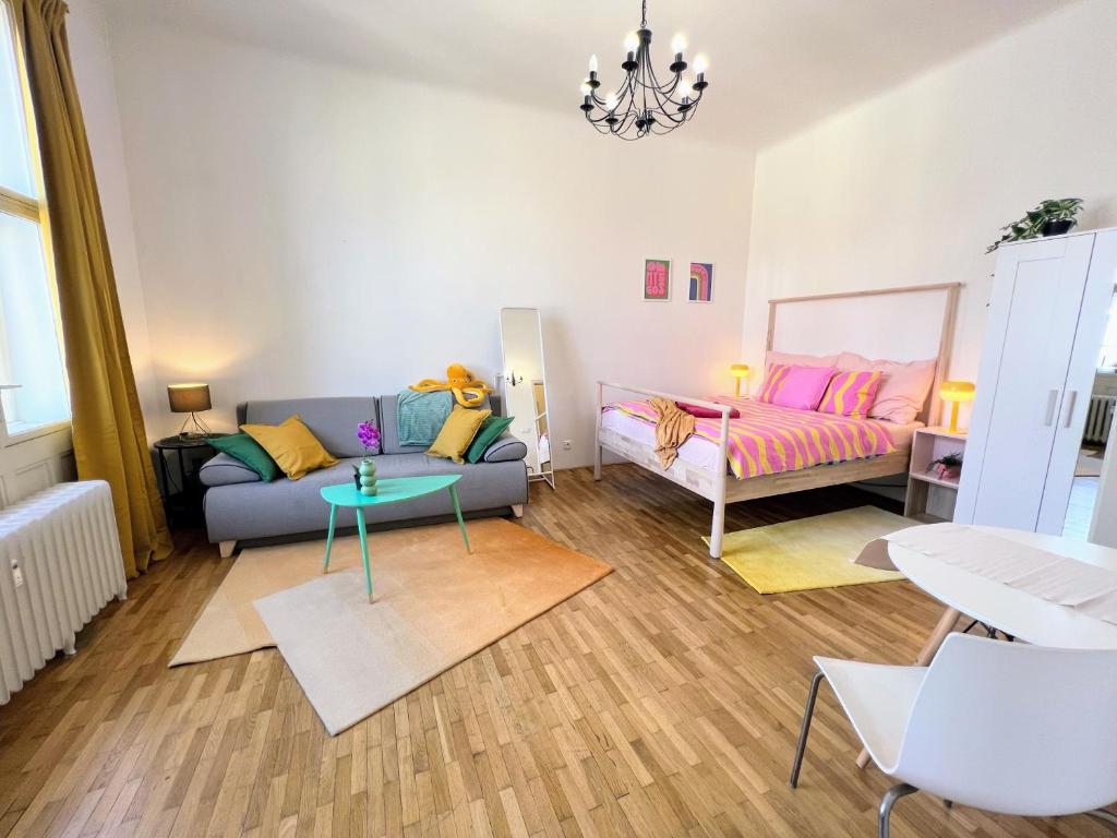 a living room with a couch and a bed at Beautiful & peaceful apartment with cute balcony in Prague