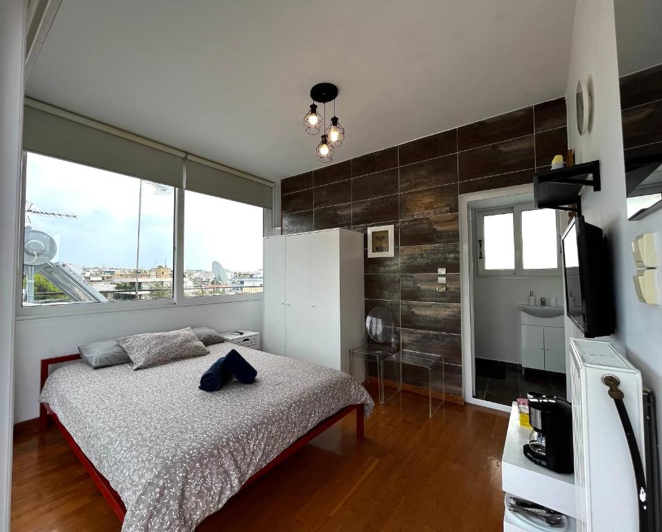 a bedroom with a bed and a large window at Glyfada One-Bedroom Studio in Athens