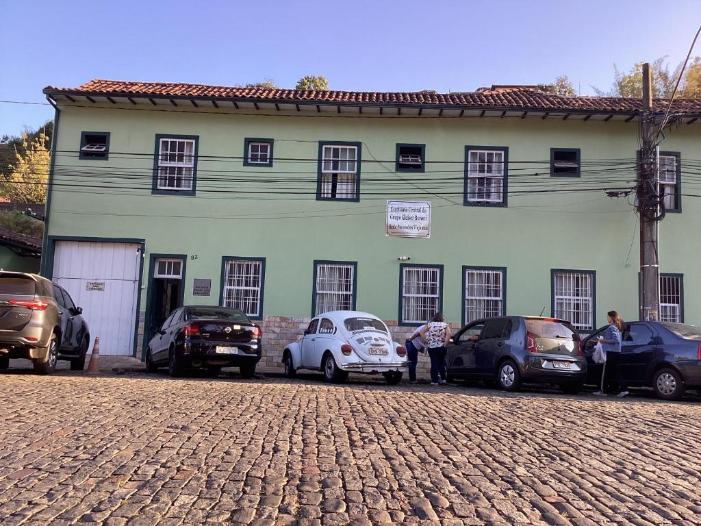 un grupo de coches estacionados frente a un edificio en Pouso dos Viajantes Unidade Centro OuroPreto en Ouro Preto