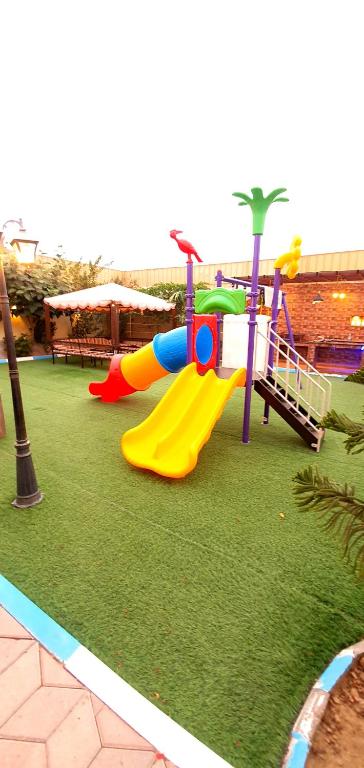 a playground with a slide at كيان ( KAYAN) in Sūr ash Shiyādī