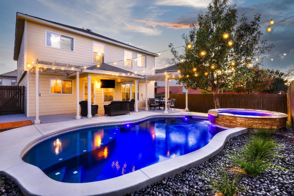 a swimming pool in the backyard of a house at Private Heated Pool & Hot Tub, 4BR Gameroom in San Antonio
