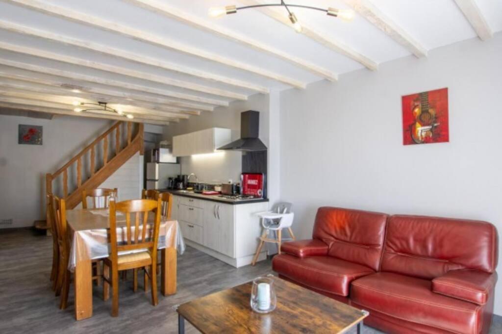 a living room with a couch and a table at Gîte Chez Pierrot - La vallée des châteaux in La Roque-Gageac