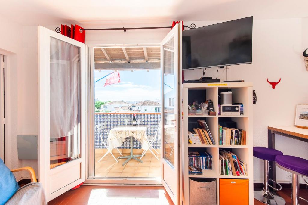 a room with a sliding glass door leading to a balcony at Le Tau in Saintes-Maries-de-la-Mer