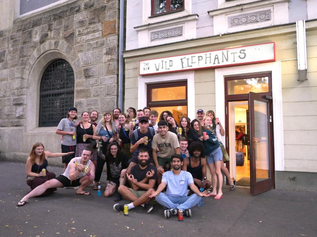a group of people posing in front of a store at Wild Elephants Hostel in Bratislava