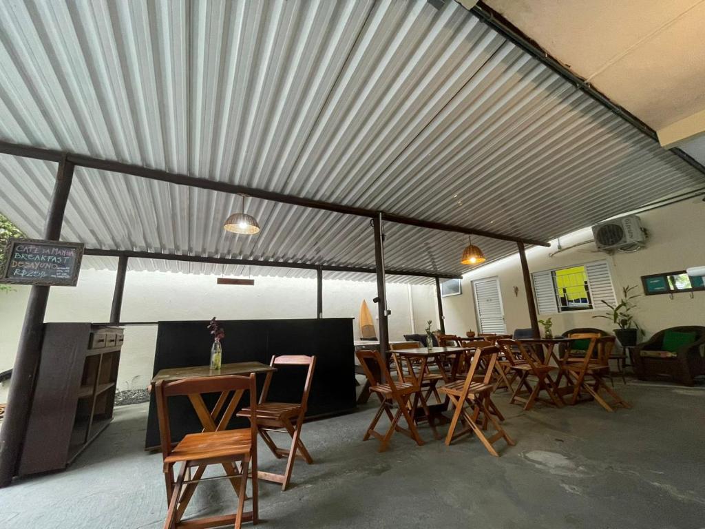 a dining area with tables and chairs under awning at CHILL INN HOSTEL & POUSADA CENTRO in Paraty