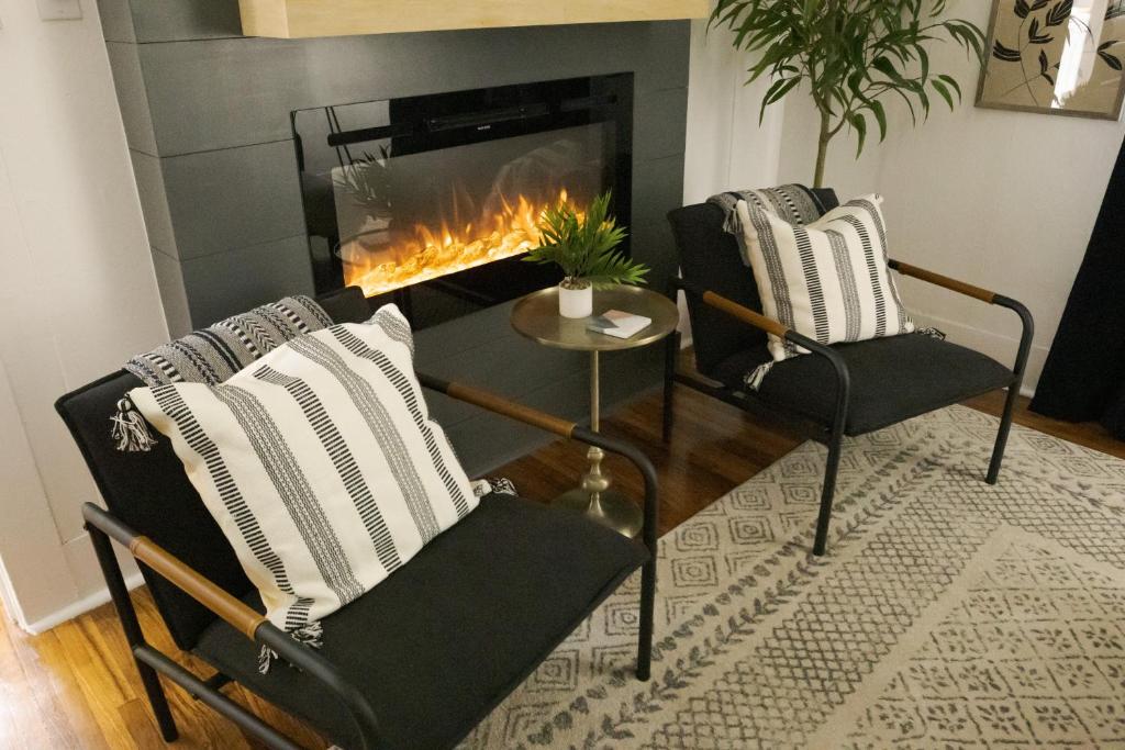 a living room with two chairs and a fireplace at Evangeline B in Lafayette