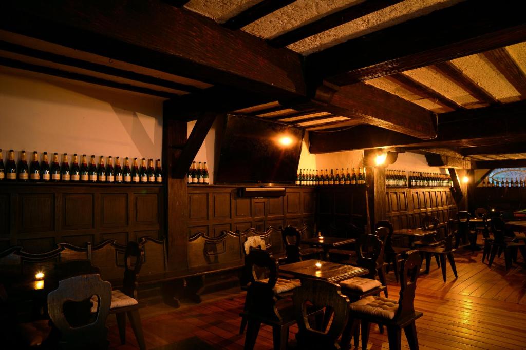 a bar with tables and chairs in a room at Mansión Papilio in Mexico City