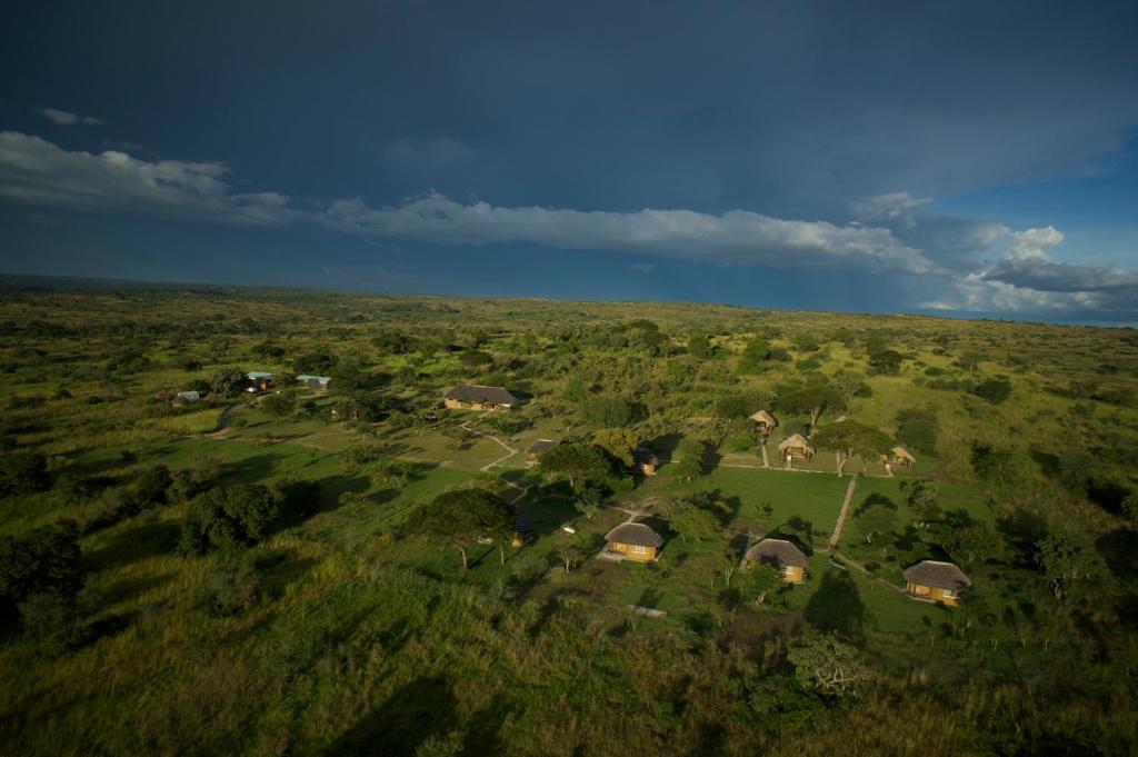 an aerial view of a house in a field at Bwana Tembo Safari Camp in Paraa