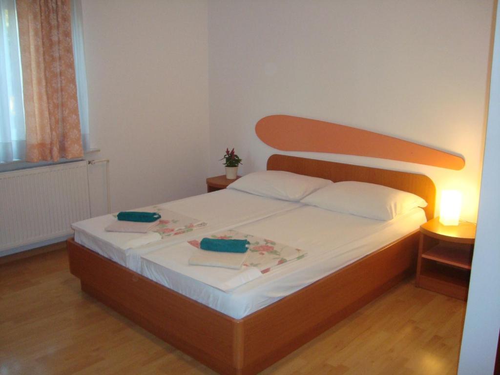 a bedroom with a bed with two plates on it at Guesthouse Koprivec in Ljubljana