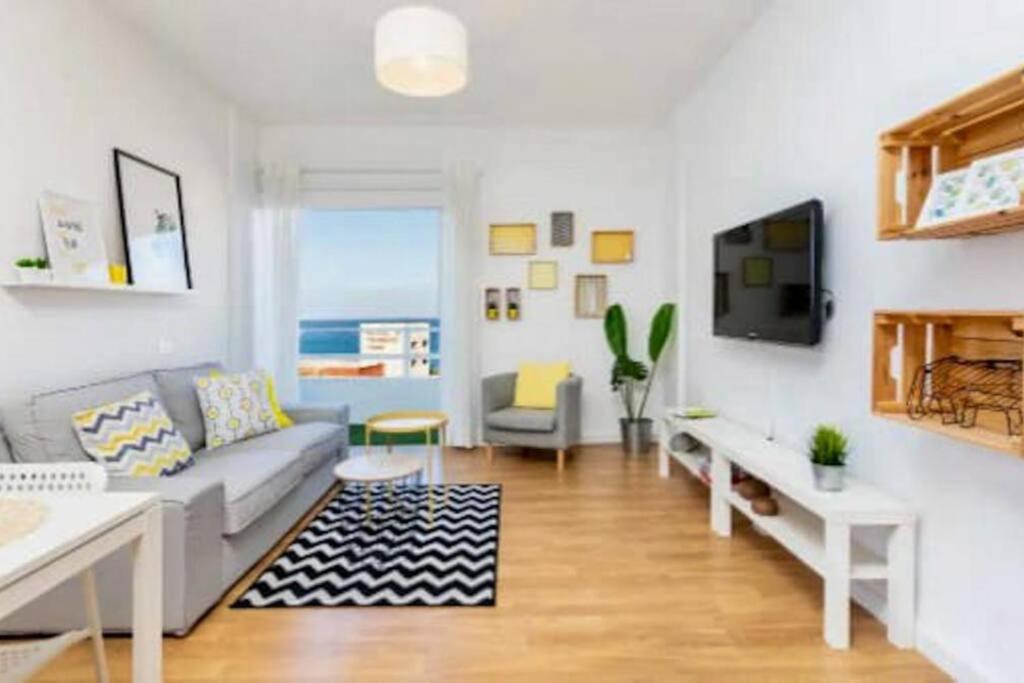 a living room with a couch and a tv at Apartamento en Candelaria in Candelaria