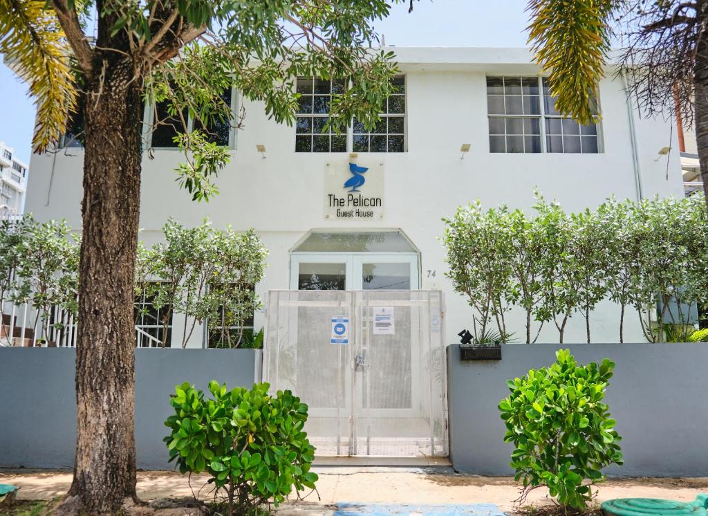 a building with a door and a tree at The Pelican Poshtel in San Juan