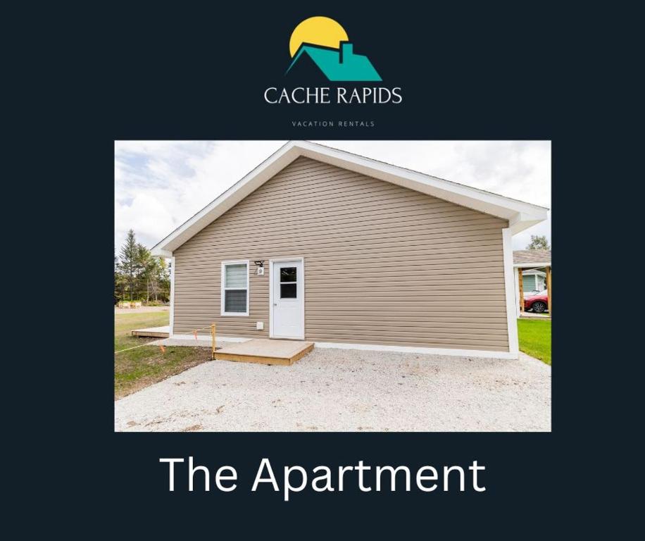 a picture of a garage with a sign that reads the apartment at The Apartment in Deer Lake