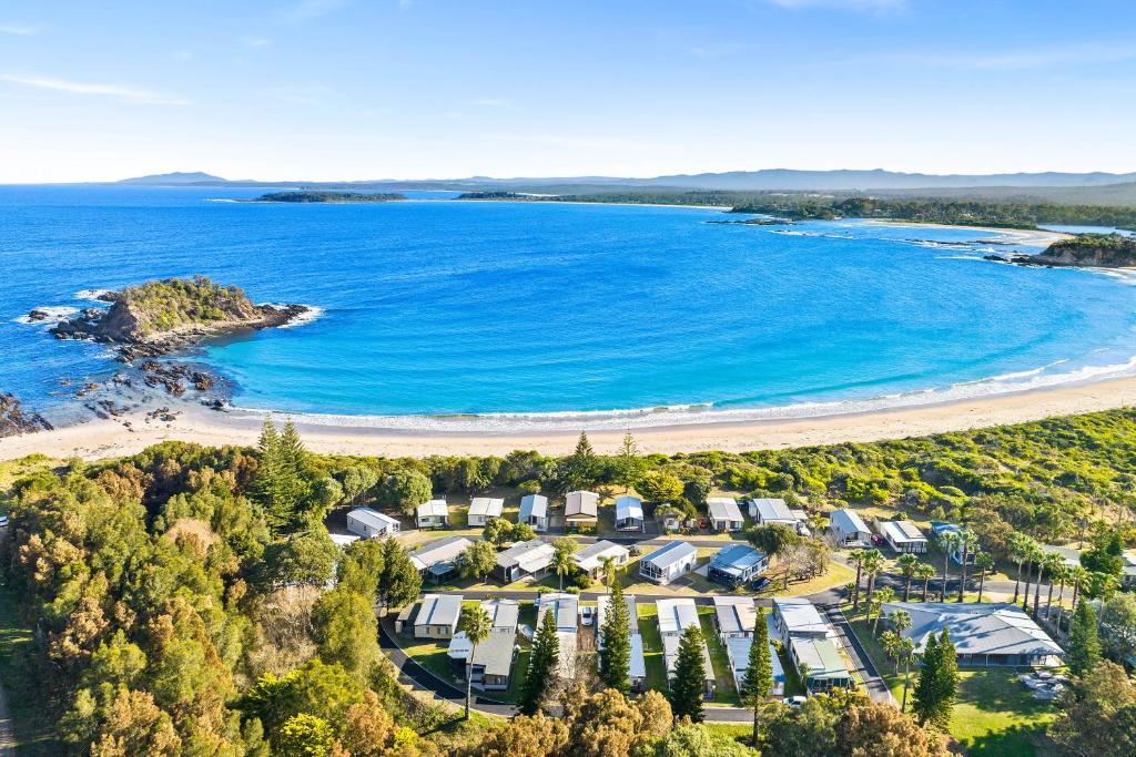 an aerial view of a beach with houses and the ocean at Barlings Beach Holiday Park in Tomakin