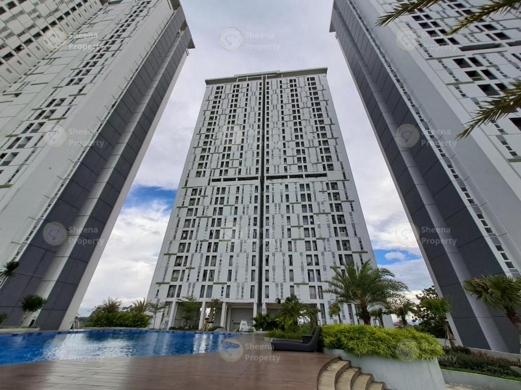 two tall buildings with a swimming pool in front of them at Sheena Property At Akasa Pure Living in Ciater-hilir