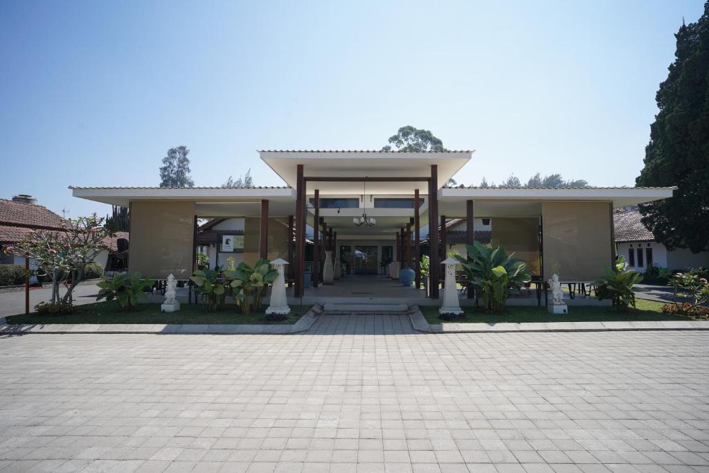 a large house with a driveway in front of it at Citere Resort Hotel in Pengalengan