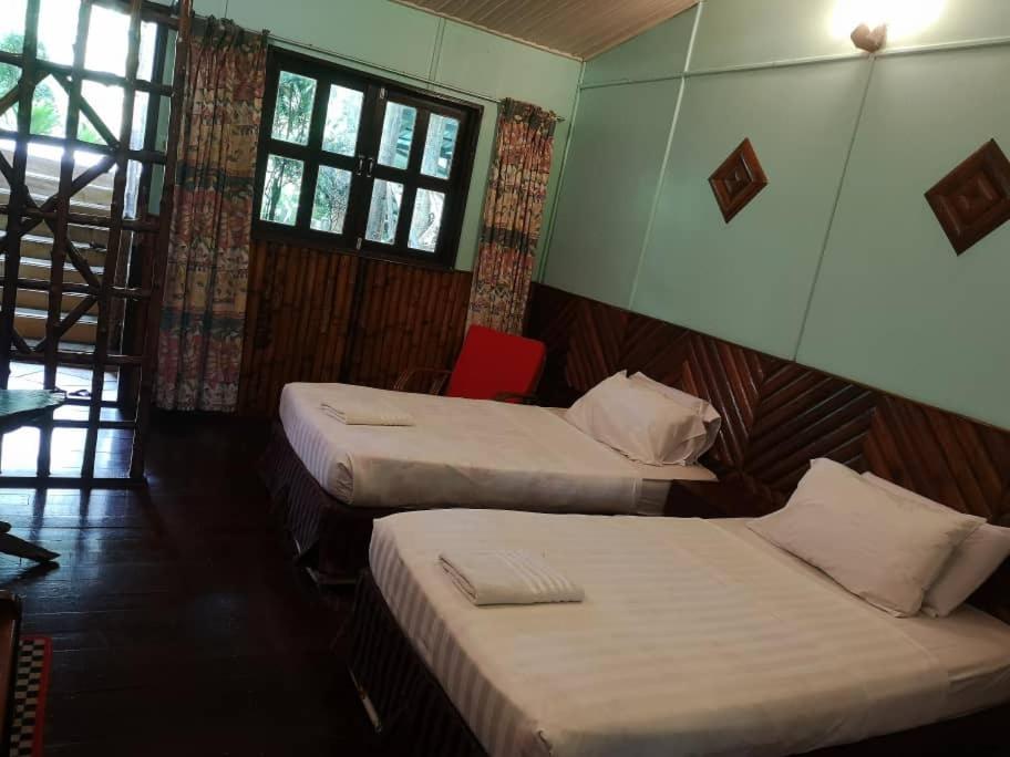Postel nebo postele na pokoji v ubytování Sepilok Jungle Resort