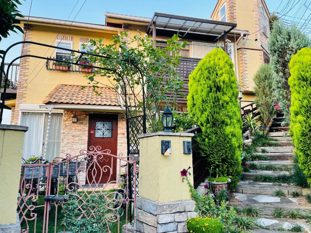 a house with a gate and a staircase in front of it at 横浜 JS HOUSE Yokohama - ペット犬可 in Yokohama