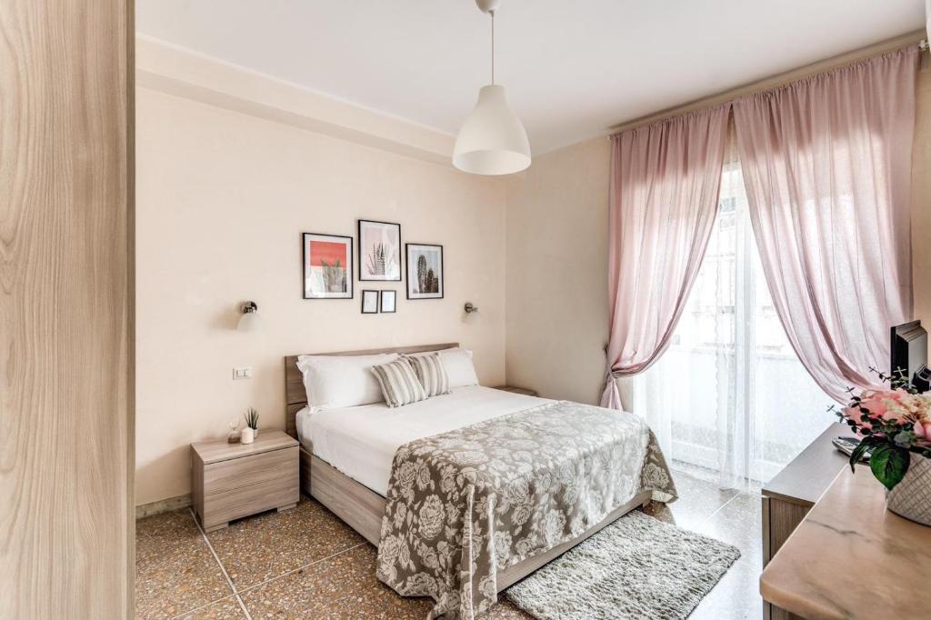 a white bedroom with a bed and a window at Rdd in Rome