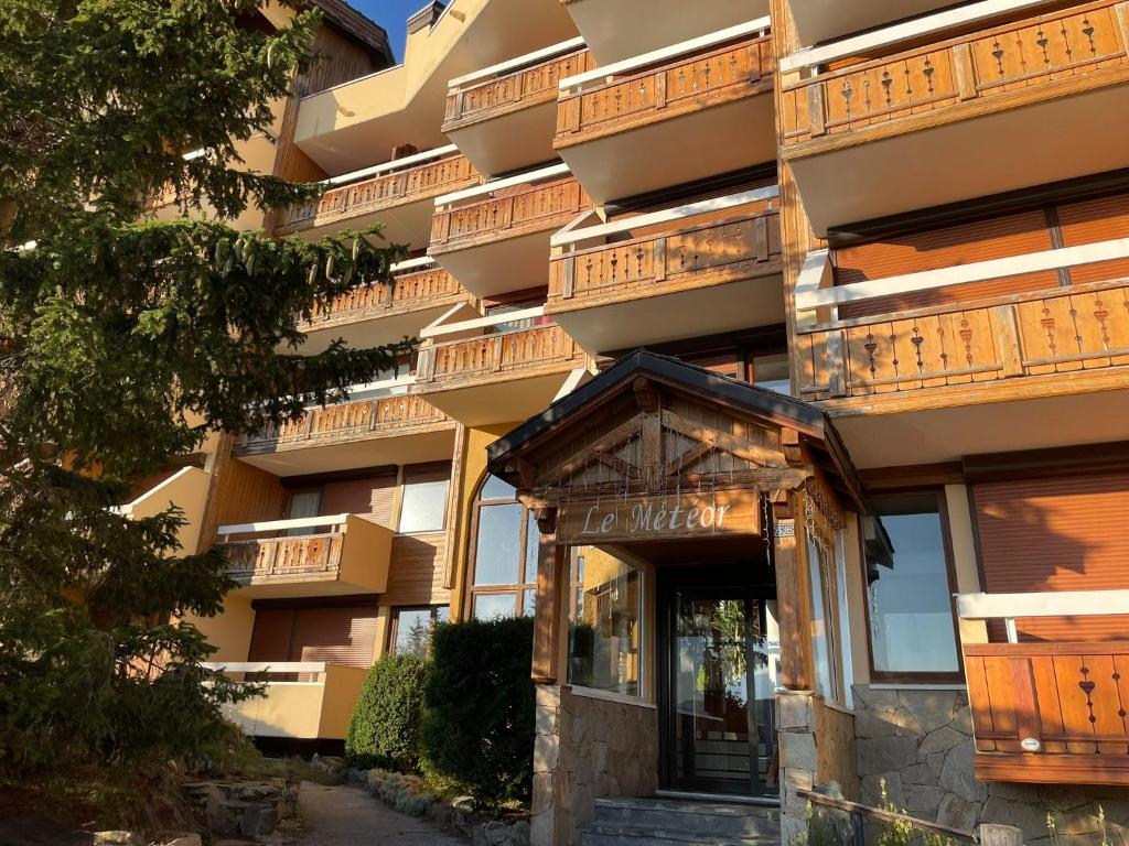 an apartment building with a door in front of it at Alpe d Huez 6 pers appart in LʼHuez