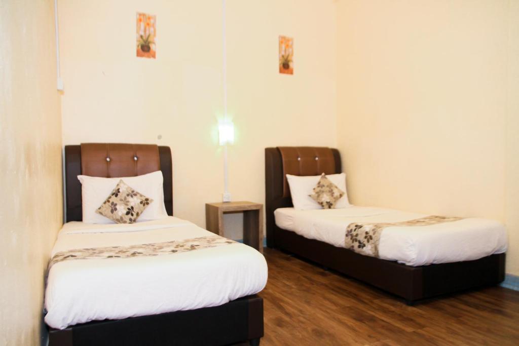 Postel nebo postele na pokoji v ubytování Myra Hotel Mersing