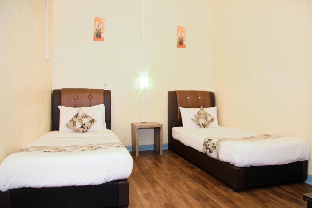 Postel nebo postele na pokoji v ubytování Myra Hotel Mersing