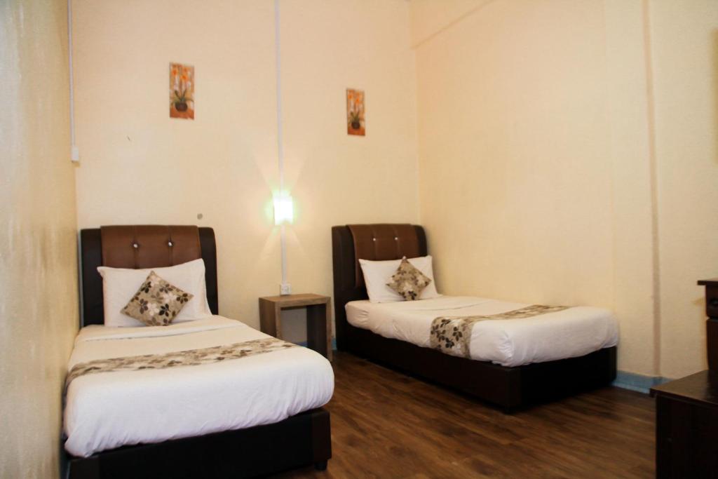 Postel nebo postele na pokoji v ubytování Myra Hotel Mersing